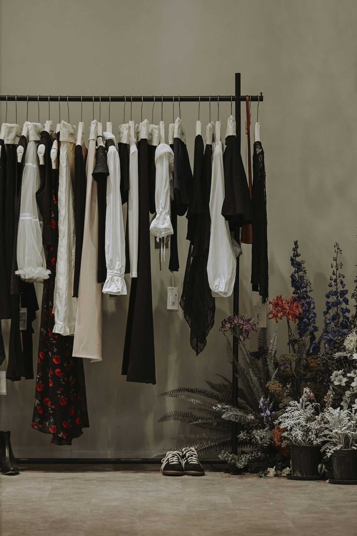 Assortment of elegant dresses hanging on a rack.